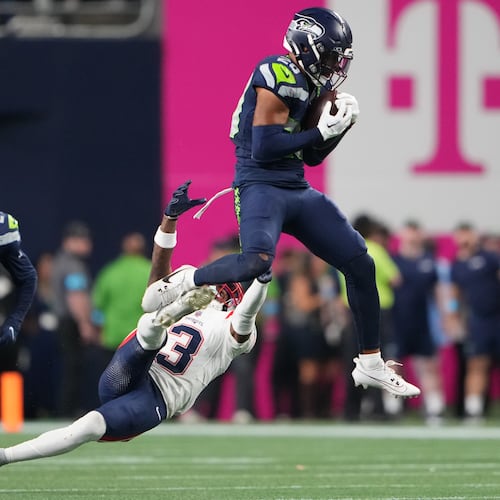 Seattle Seahawks safety Julian Love (20) intercepts a pass intended for New England Patriots wide receiver DeMario Douglas (3) as New England Patriots safety Dell Pettus (24) looks on during the second half of an NFL football game, Wednesday, Sept. 9, 2026, in Seattle. (AP Photo/Lindsey Wasson)