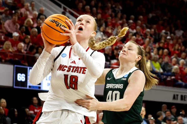 North Carolina State's Tilda Trygger (18) drives the ball past Michigan State's Julia Ayrault (40) during the second half in the second round of the NCAA college basketball tournament in Raleigh, N.C., Monday, March 24, 2025. (AP Photo/Karl DeBlaker)