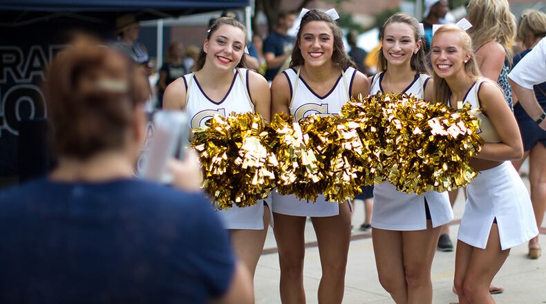 Kitty Shipp (left) takes a photo of Georgia Tech cheerleaders during the Jackets' annual fan day at Callaway Plaza outside of Bobby Dodd Stadium, Saturday, Aug. 8, 2015, in Atlanta.