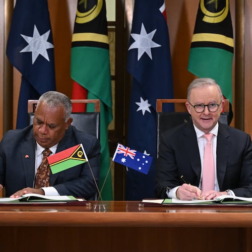 Prime Minister of Vanuatu Jotham Napat, left, and Australian Prime Minister Anthony Albanese sign the Nakamal agreement at Parliament House in Canberra, Monday, June 29, 2026. (Lukas Coch/AAP Image via AP)