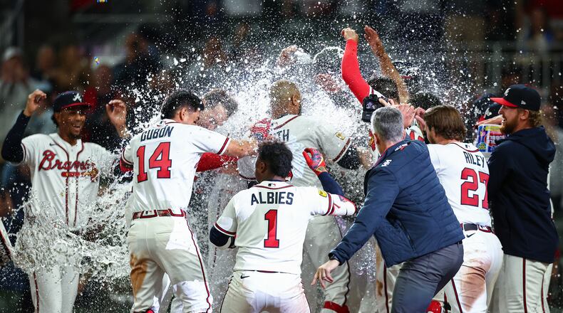 The Braves celebrate at home plate after a walk-off grand slam from Dominic Smith (center) in the ninth inning against the Royals on Saturday, March 28, 2026, in Atlanta. (Colin Hubbard/AP)