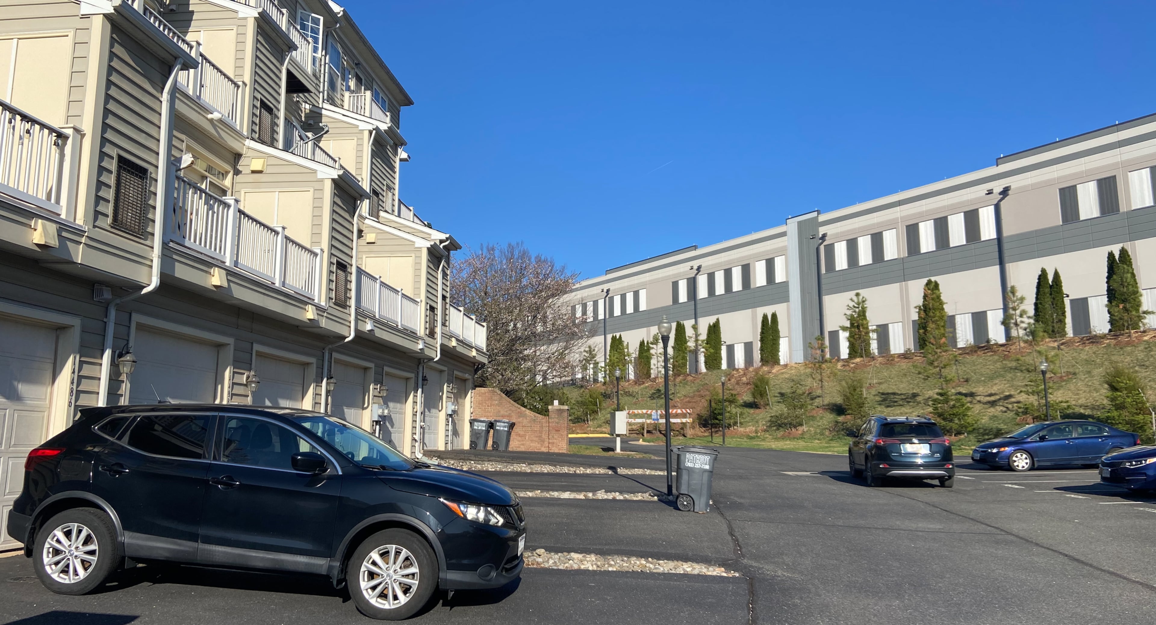 Data centers such as this one abutting a residential neighborhood in Prince William County, Virginia, have been prized by local leaders for the tax dollars they bring in, which in turn lower tax rates for homeowners and bankroll schools. (Zachary Hansen/AJC)