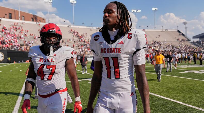North Carolina State quarterback CJ Bailey (11) walks off the field after the team's loss in an NCAA college football game against Vanderbilt, Saturday, Sept. 19, 2026, in Nashville, Tenn. (AP Photo/George Walker IV)