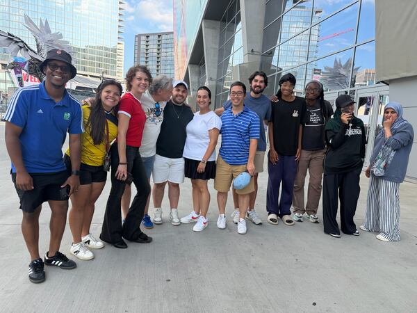 Atlanta sports marketer Vince Thompson (fourth from left) with a group of family, friends, associates and members of the Soccer in the Streets community pose for a photo at the Haiti-Morocco World Cup game. (Photo courtesy Vince Thompson)