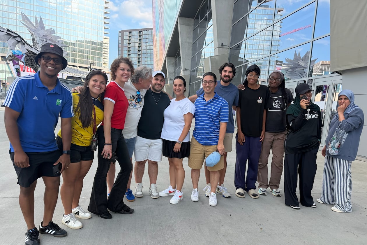 Atlanta sports marketer Vince Thompson (fourth from left) with a group of family, friends, associates, members of the Soccer in the Streets community and an AJC writer pose for a photo outside Mercedes-Benz Stadium at the Haiti-Morocco World Cup game June 24, 2026. (Photo courtesy of Vince Thompson)