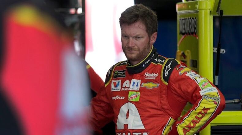 FILE - In this May 19, 2017, file photo, Dale Earnhardt Jr. watches crew members work on his car during practice for a NASCAR Cup series All-Star auto race at Charlotte Motor Speedway in Concord, N.C. Before Dale Earnhardt Jr. calls it a career and starts calling races for NBC, he'd like to salvage a few positive memories from this season. (AP Photo/Chuck Burton, File)