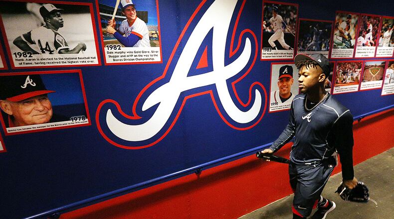 Braves outfielder Ronald Acuna walks down the tunnel at the franchise's former spring training home past an image of Hall of Famer Hank Aaron among others. (Curtis Compton/ccompton@ajc.com).