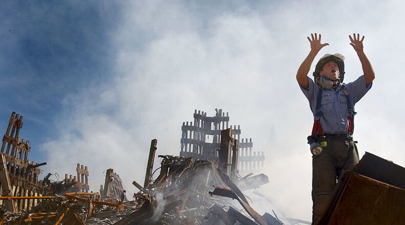 A New York City fireman calls for 10 more rescue workers to make their way into the rubble of the World Trade Center September 14, 2001 days after the September 11, 2001 terrorist attack. (U.S. Navy Photo by Jim Watson/Getty Images)