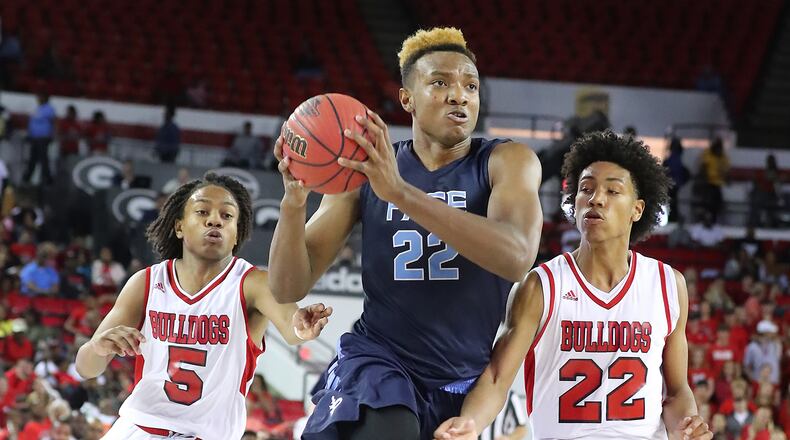 Pace Academy center Wendell Carter drives to the basket past Morgan County defenders Stevin Green (left) and Alec Woodard in their Class AAA boys state basketball championship game on Thursday, March 9, 2017, in Athens. Curtis Compton/ccompton@ajc.com