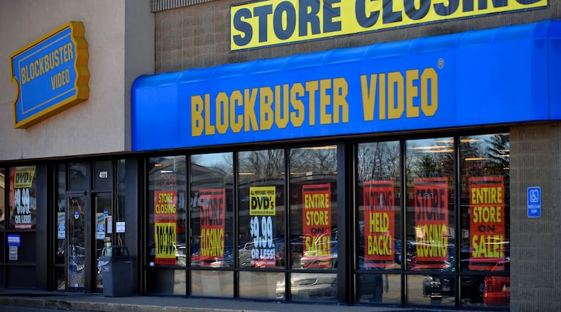 FILE - This March 17, 2010, file photo, shows a closing Blockbuster stores in Racine, Wis. Dish Network announced Wednesday, Nov. 6, 2013, it will close the remaining 300 Blockbuster locations scattered across the United States. Dish Network expects the stores to be closed by early January. Dish Network says about 2,800 people will lose their jobs. (AP Photo/Journal Times, Scott Anderson, File)