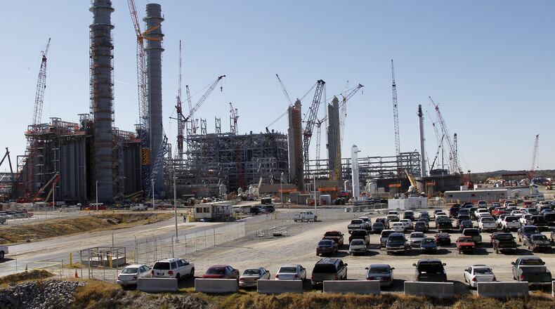 Workers vehicles fill parking lots at Mississippi Power’s Kemper County energy facility near DeKalb, Miss., in this 2012 photo. Delays and cost overruns at the “clean coal” plant have weighed on Southern Co.’s bottom line. (AP Photo/Rogelio V. Solis, File)