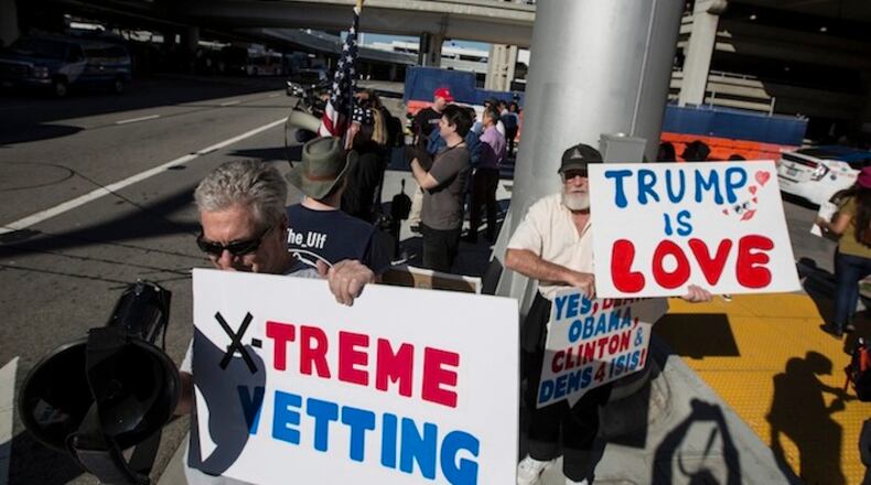 Donald Trump supporters across the road from protesters against an immigration order by the president on Sunday, Jan. 29, 2017 at the Tom Bradley International Terminal at Los Angeles International Airport. (Brian van der Brug/Los Angeles Times/TNS)