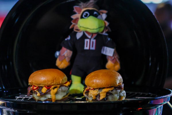 One of the food options at the new Sports Illustrated Lounge at Mercedes-Benz Stadium is the Freddie Burger, layered with black pepper bacon, gruyere cheese and pickled Fresno chilis. (Miguel Martinez/ AJC)