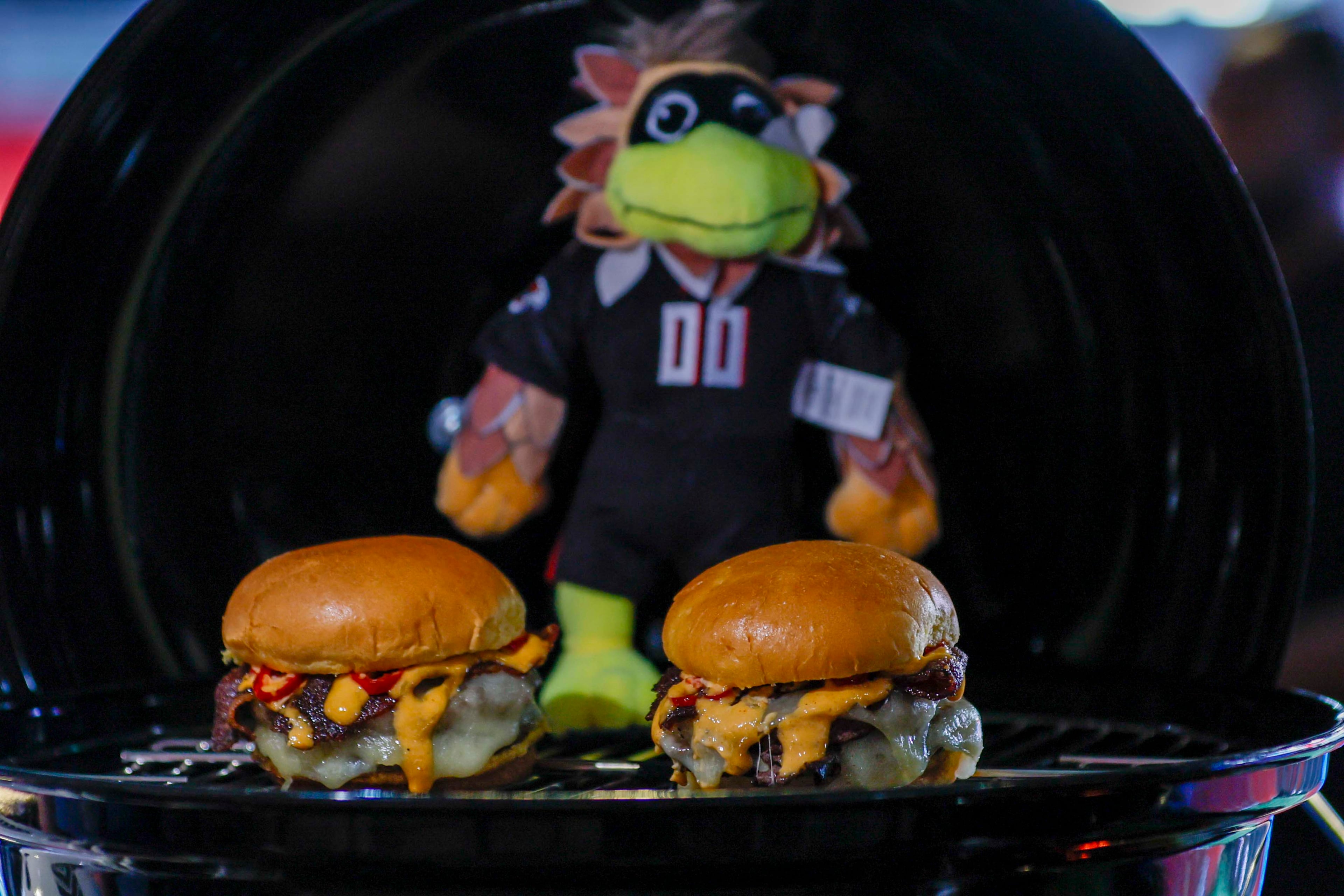 One of the food options at the new Sports Illustrated Lounge at Mercedes-Benz Stadium is the Freddie Burger, layered with black pepper bacon, gruyere cheese and pickled Fresno chilis. (Miguel Martinez/ AJC)