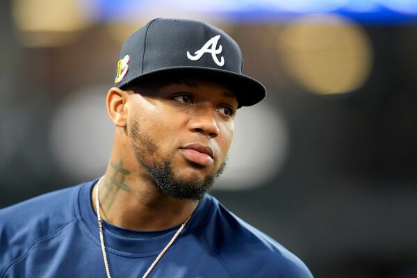 FILE - Atlanta Braves' Ronald Acuna Jr. stands in the dugout during the fifth inning of a baseball game against the Los Angeles Angels, on Aug. 17, 2024, in Anaheim, Calif. (AP Photo/Ryan Sun, File)