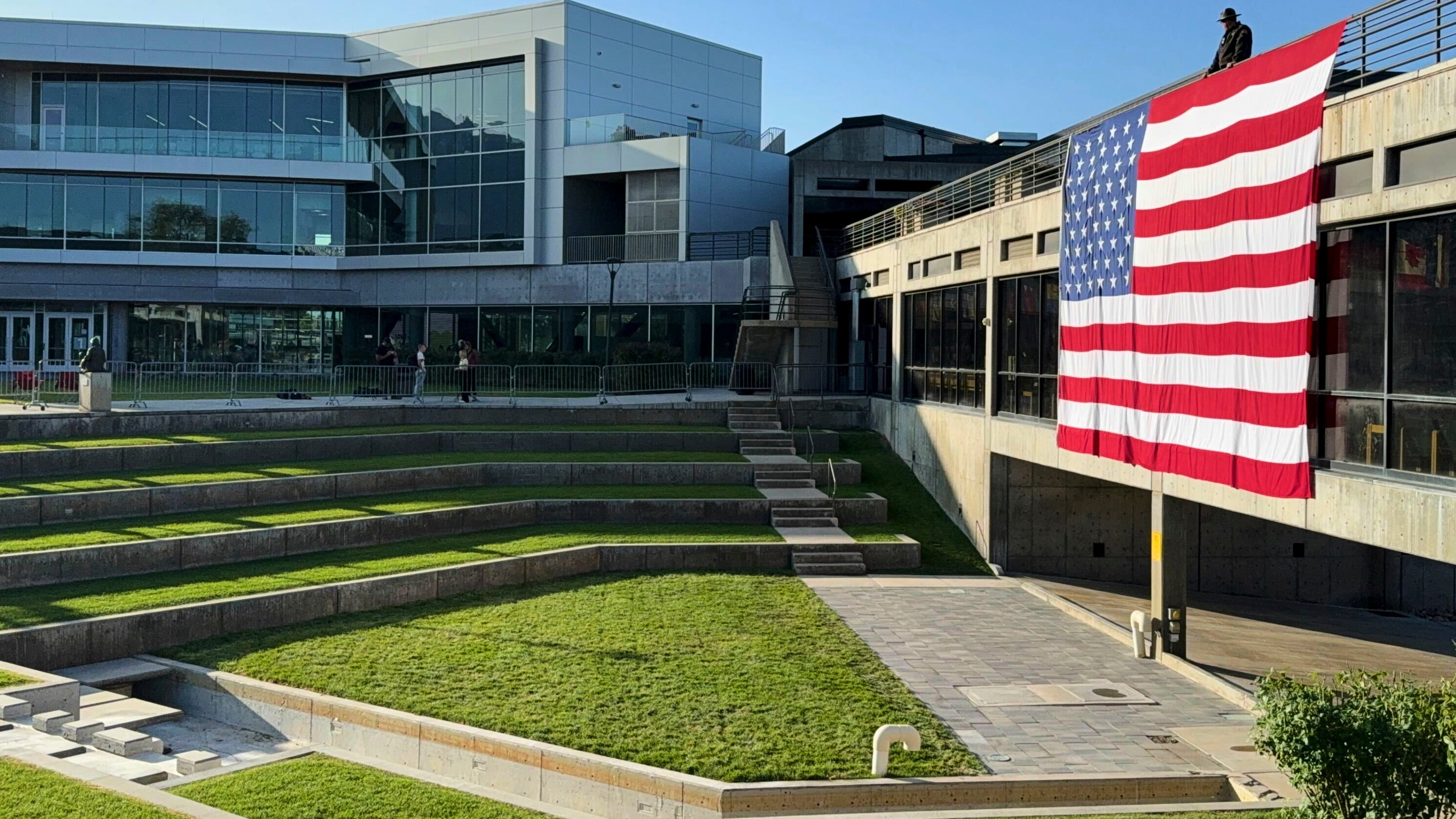 FILE - A national flag hangs over the site where conservative activist Charlie Kirk was shot and killed, at Utah Valley University, Sept. 17, 2025, in Orem, Utah. (AP Photo/Jesse Bedayn, File)
