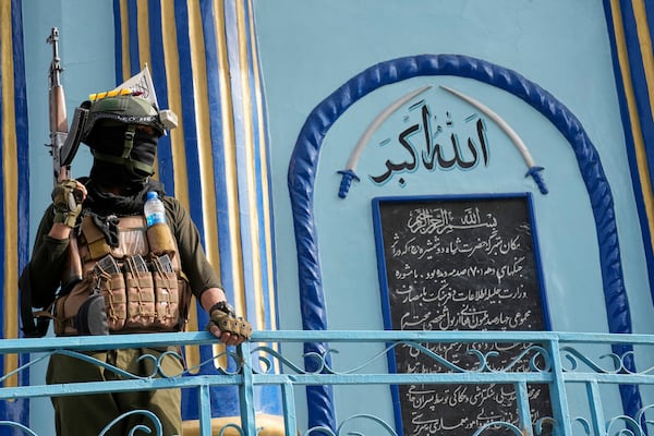 A Taliban fighter stands guard next to the Shah-Do Shamshira Mosque while people attend the Eid al-Adha prayer in Kabul, Afghanistan, Saturday, June 7, 2025. (AP Photo/Ebrahim Noroozi)