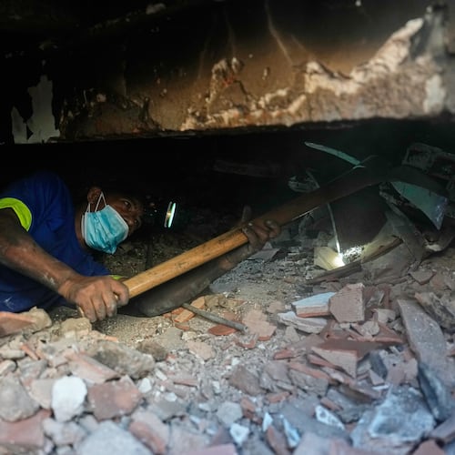 Franklin Rodriguez searches for missing relatives in the rubble of his apartment building, which collapsed in the back-to-back earthquakes that struck La Guaira, Venezuela, Monday, June 29, 2026. (AP Photo/Fernando Vergara)