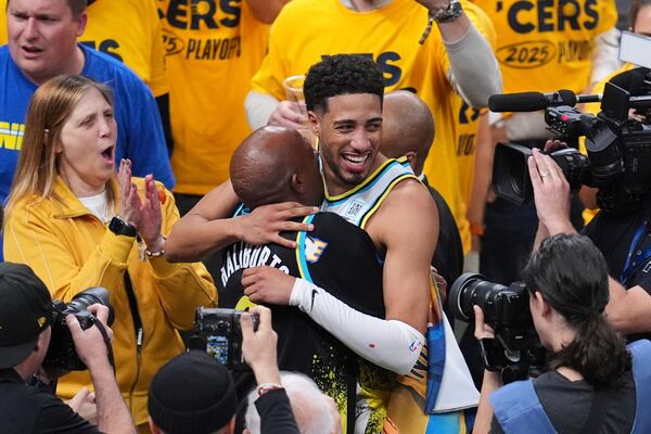 Indiana Pacers guard Tyrese Haliburton (0) hugs his father John Haliburton following Game 5 of an NBA basketball first-round playoff series against the Milwaukee Bucks, Tuesday, April 29, 2025, in Indianapolis. (AP Photo/Michael Conroy)