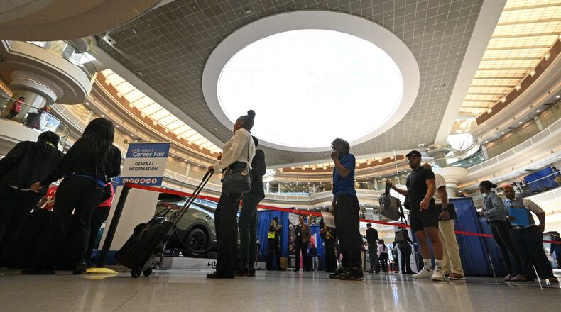 Job seekers stand in line at check-in desk during the ATL Airport Career Fair at Hartsfield-Jackson Atlanta International Airport. Employers at the fair were dangling 2,300 positions including managerial roles and jobs with airlines, cargo, maintenance, concessions and other companies. (Hyosub Shin / Hyosub.Shin@ajc.com)