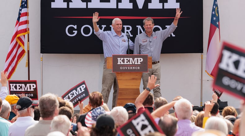 Former Vice President Mike Pence, left, campaigns Tuesday in Cumming with Gov. Brian Kemp. Pence called Kemp “singularly one of the most successful conservative governors.” (Arvin Temkar / arvin.temkar@ajc.com)