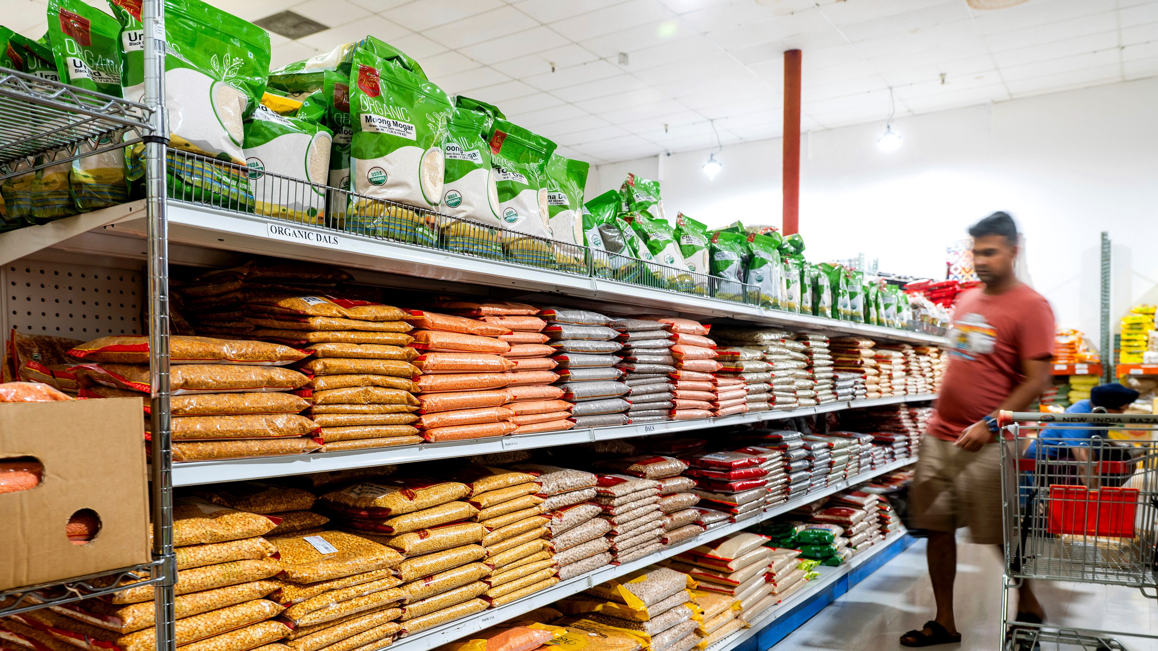 A customer shops a grain isle at New India Bazar, where most merchandise is imported from India and Canada, on Wednesday, Aug. 6, 2025, in Fremont, Calif. (AP Photo/Noah Berger)