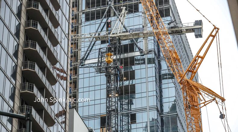 Crews are working to remove the crane, which malfunctioned as it was being disassembled.