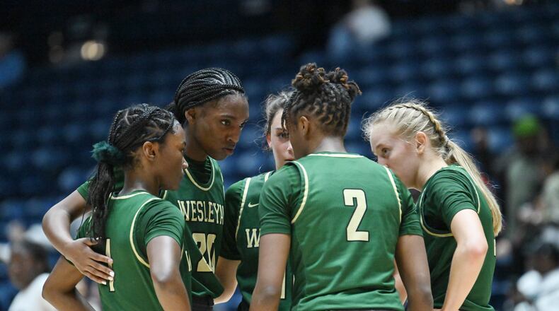 Wesleyan players confer during the first half of GHSA Basketball Class 3A Girl’s State Championship game at the Macon Centreplex, Friday, Mar. 8, 2024, in Macon. (Hyosub Shin / Hyosub.Shin@ajc.com)