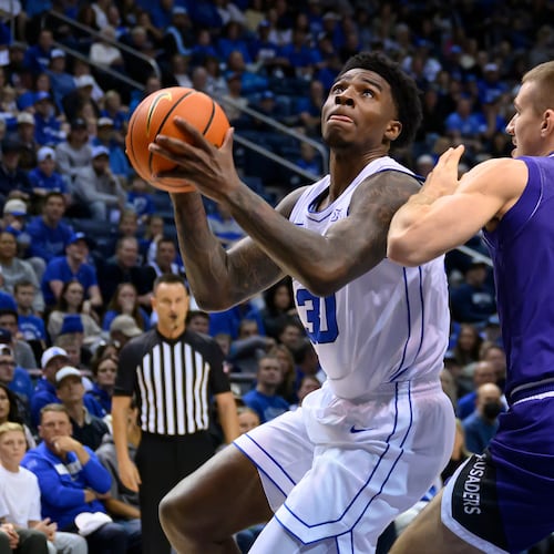 BYU forward Kennard Davis Jr. drives to the basket guarded by Holy Cross guard Joe Nugent (30) during the first half of an NCAA college basketball game, Saturday, Nov. 8, 2025, in Provo, Utah. (AP Photo/Tyler Tate)