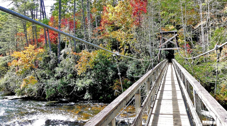 The Benton MacKaye Trail takes hikers over the rugged Toccoa River in Fannin County via the famed "swinging bridge" (shown here). The Benton MacKaye Trail Association now wants Congress to designate the trail as the nation's 12th "National Scenic Trail." (Charles Seabrook for The Atlanta Journal-Constitution)