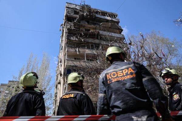 Rescue workers inspect a multi-storey building damaged by a Russian strike on residential neighbourhood in Zaporizhzhia, Ukraine, on Tuesday, April 22, 2025. (AP Photo/Kateryna Klochko)