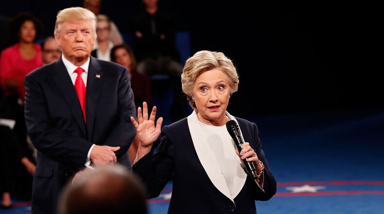 Hillary Clinton speaks as Donald Trump listens during the town hall debate at Washington University. (Photo by Rick Wilking-Pool/Getty Images)