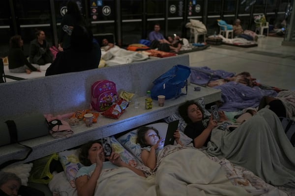 People take shelter in an underground metro station as a precaution against possible Iran missile attacks, in Ramat Gan, near Tel Aviv, Israel, Tuesday, June 17, 2025. (AP Photo/Oded Balilty)
