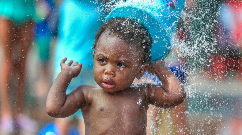 Michael Watts, 16 months, enjoyed a field trip with mother Kayla Watts (not pictured), who brought her East Lake Early Learning Academy Pre-K class on their year-end field trip to the Splashpad at Atlanta’s Historic Fourth Ward Park on Fri., June 24, 2016. JOHN SPINK / JSPINK@AJC.COM