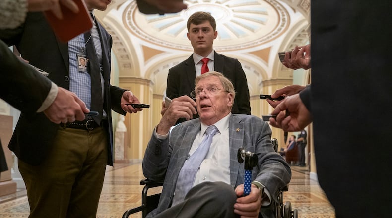 In this photo taken Tuesday, April 9, 2019, Sen. Johnny Isakson, R-Ga., talks to reporters just outside the chamber as Senate negotiations over a disaster relief package for Puerto Rico broke down, at the Capitol in Washington. Six months after hurricanes devastated the Southeast, Washington infighting has shelved a widely backed disaster aid package that President Donald Trump's allies in Florida and Georgia are desperately seeking. (AP Photo/J. Scott Applewhite)