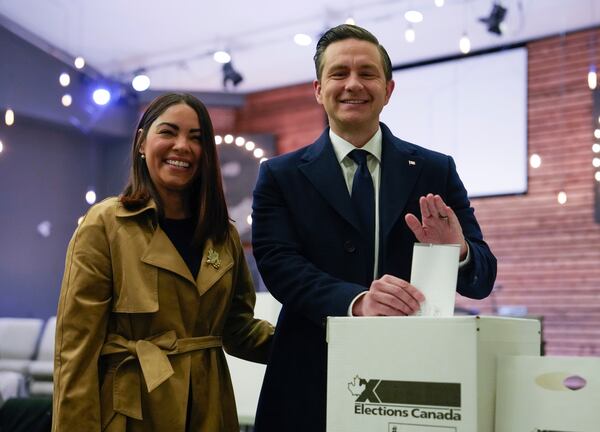 Conservative Leader Pierre Poilievre, right, and his wife Anaida Poilievre cast their votes in the federal election in Ottawa, Canada, Monday, April 28, 2025 in Ottawa. (Adrian Wyld/The Canadian Press via AP)