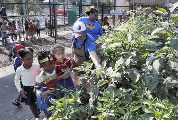Germaine Appel (center), the garden educator at Little Ones Learning Center in Forest Park, during a session with kids in the school garden on Sept. 11, 2019.  