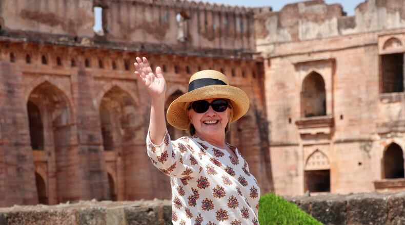 In this Monday, March 12, 2018 photo, former U.S. Secretary of State Hillary Clinton, waves to media as she visits the Jahaz Mahal monument in Mandu, Madhya Pradesh state, India. (AP Photo)