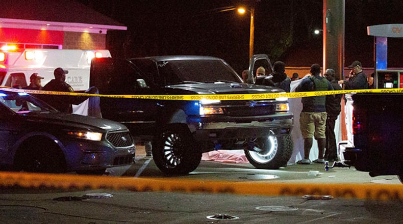Deputies, police and state law enforcement work the scene of a QV gas station in Hayneville, Ala., where Lowndes County Sheriff John Williams was shot and killed Saturday.