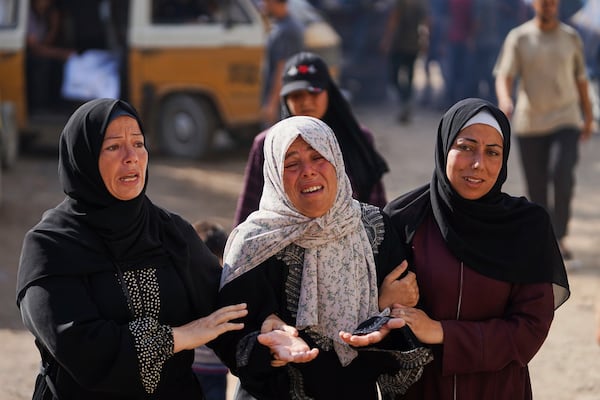 Relatives of Palestinians killed in Israeli strikes on the Gaza Strip mourn their deaths at Al-Shifa Hospital in Gaza City, Saturday, June 28, 2025. (AP Photo/Jehad Alshrafi)