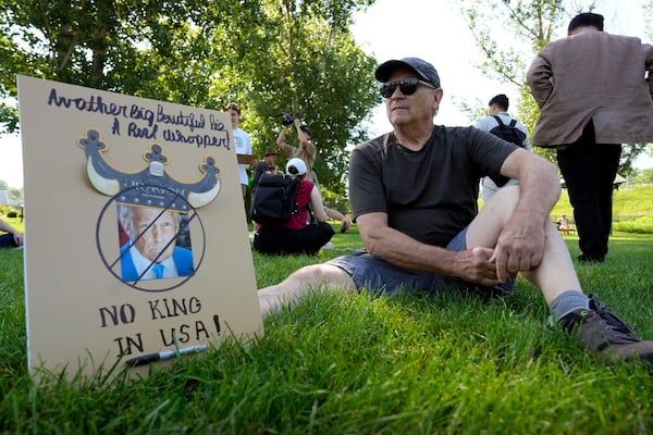 Dana Myers, of Des Moines, Iowa, waits for the start of an Iowa Democratic Party rally, Thursday, July 3, 2025, in Windsor Heights, Iowa. (AP Photo/Charlie Neibergall)