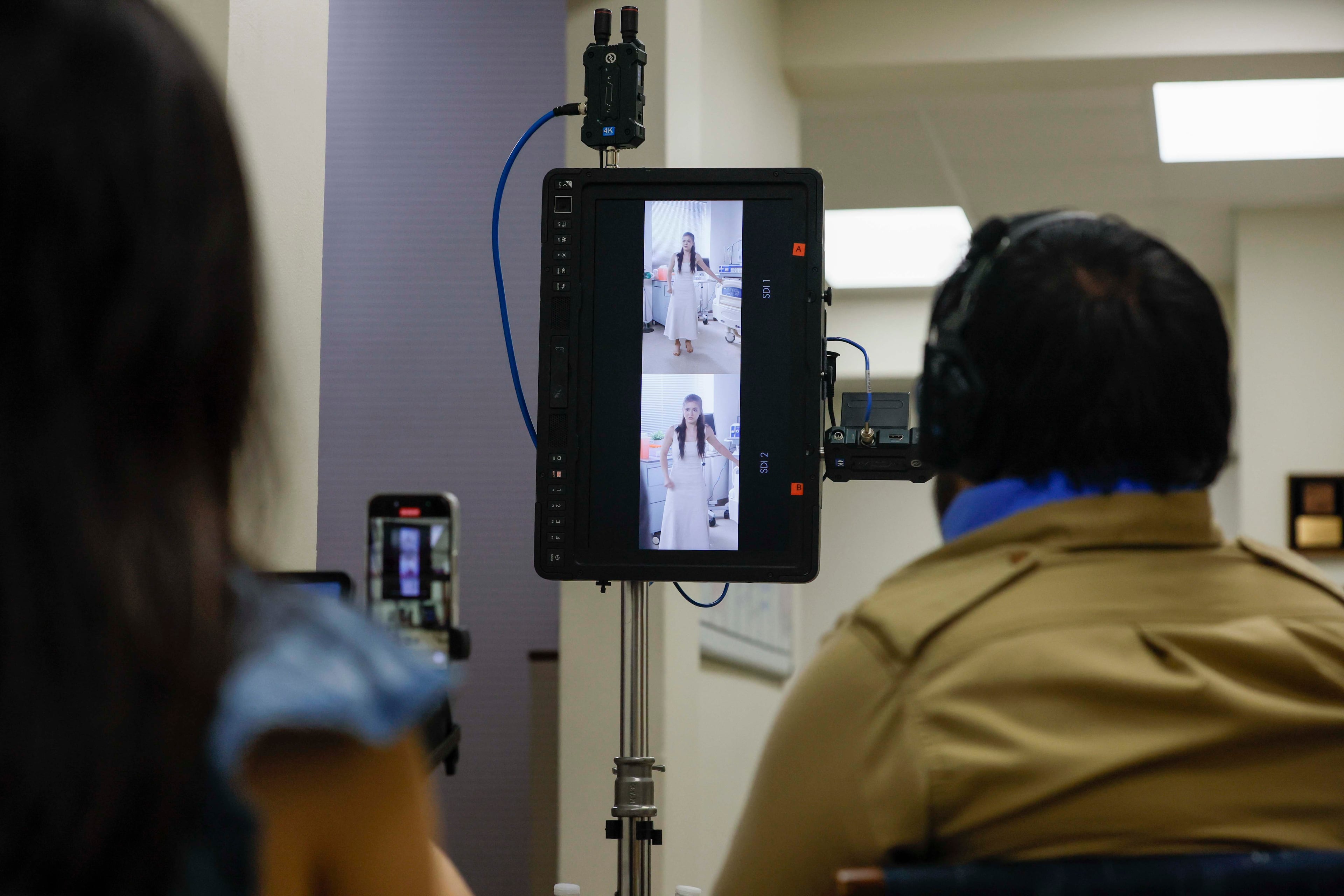 Film crew members observed a scene being filmed in a vertical format as actors performed in a production by Crazy Stone Studio for a project called for now "Billionaire Defense Contractor" on Wednesday, June 25, 2025. Production companies have found various ways to keep people employed filming projects in the vertical format during a slow period for Georgia’s film and television industry.
(Miguel Martinez/ AJC)