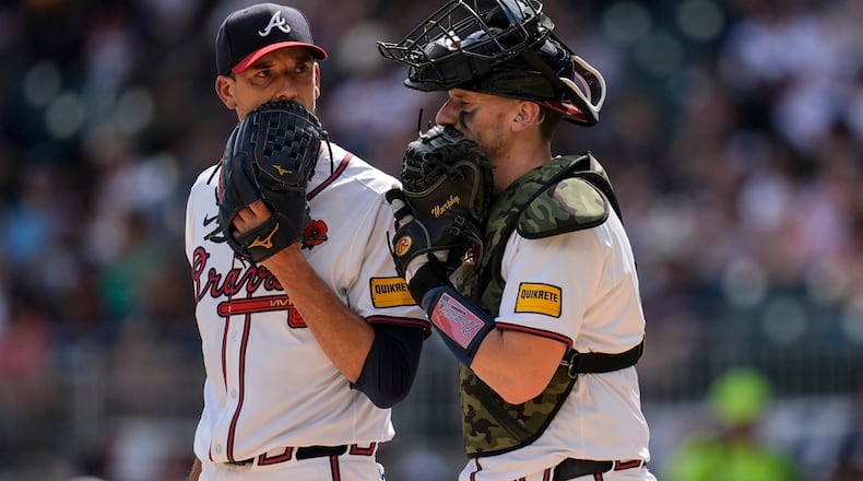 Atlanta Braves pitcher Charlie Morton, left, and catcher Sean Murphy speak on the mound in the first inning of a baseball game against the Washington Nationals, Monday, May 27, 2024, in Atlanta. (AP Photo/Mike Stewart)