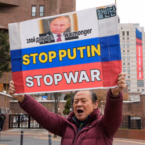 A South Korean protester holds a banner to denounce Russia's invasion of Ukraine on the fourth anniversary of the Russia-Ukraine war, near the Russian Embassy in Seoul, South Korea, Tuesday, Feb. 24, 2026. A banner reads "Victory will be ours." (AP Photo/Ahn Young-joon)