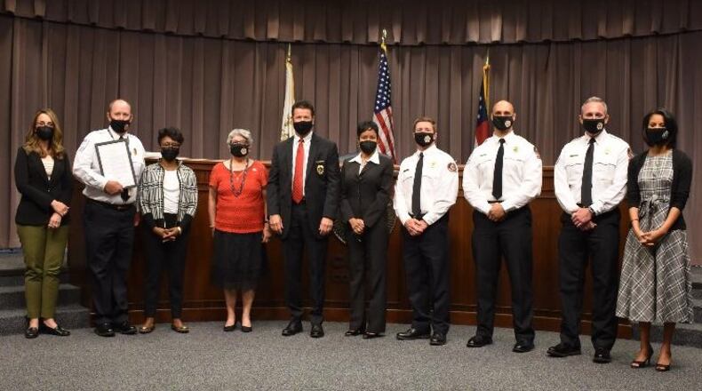 Attending an April 13 ceremony by the Cobb County Board of Commissioners to mark the 50th anniversary of Cobb County Fire and Emergency Services are (L-R) Commissioner Keli Gambrill, Fire Chief Bill Johnson, Chairwoman Lisa Cupid, Commissioner JoAnn K. Birrell, Public Safety Director Randy Crider, Commissioner Monique Sheffield, Deputy Fire Chief Kevin Gross, Chief of Staff Mike Cunningham, Deputy Fire Chief Carl Crumley and Commissioner Jerica Richardson. (Courtesy of Cobb County)