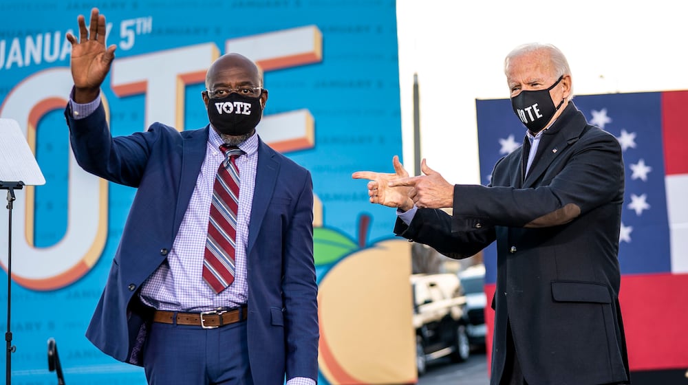 FILE — Rev. Raphael Warnock, Democratic Senate candidate, with President-elect Joe Biden at a rally in Atlanta, Jan. 4, 2021. Data suggest that threats are particularly acute against lawmakers of color. Warnock has doled out nearly $900,000 for his own protection since 2021 — the most of any member of Congress. (Doug Mills/The New York Times)