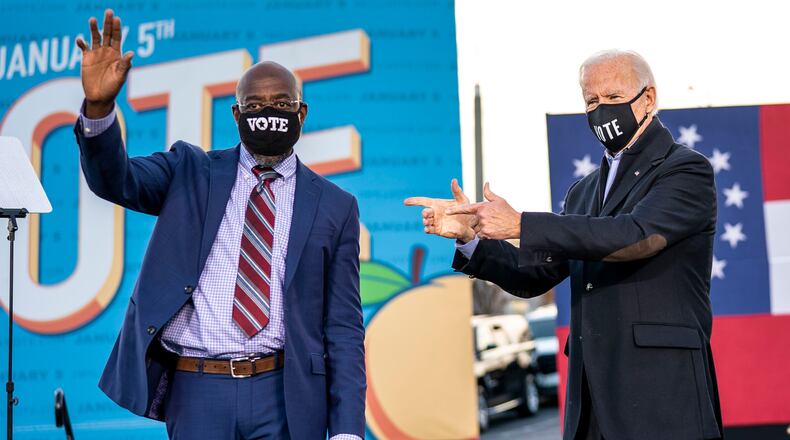 FILE — Rev. Raphael Warnock, Democratic Senate candidate, with President-elect Joe Biden at a rally in Atlanta, Jan. 4, 2021. Data suggest that threats are particularly acute against lawmakers of color. Warnock has doled out nearly $900,000 for his own protection since 2021 — the most of any member of Congress. (Doug Mills/The New York Times)