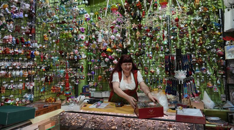 Owner of the Christel Dauwe Collection ornaments shop, Christel Dauwe, wraps boxes of holiday ornaments at her shop in Antwerp, Belgium, Monday, Dec. 8, 2025. (AP Photo/Virginia Mayo)