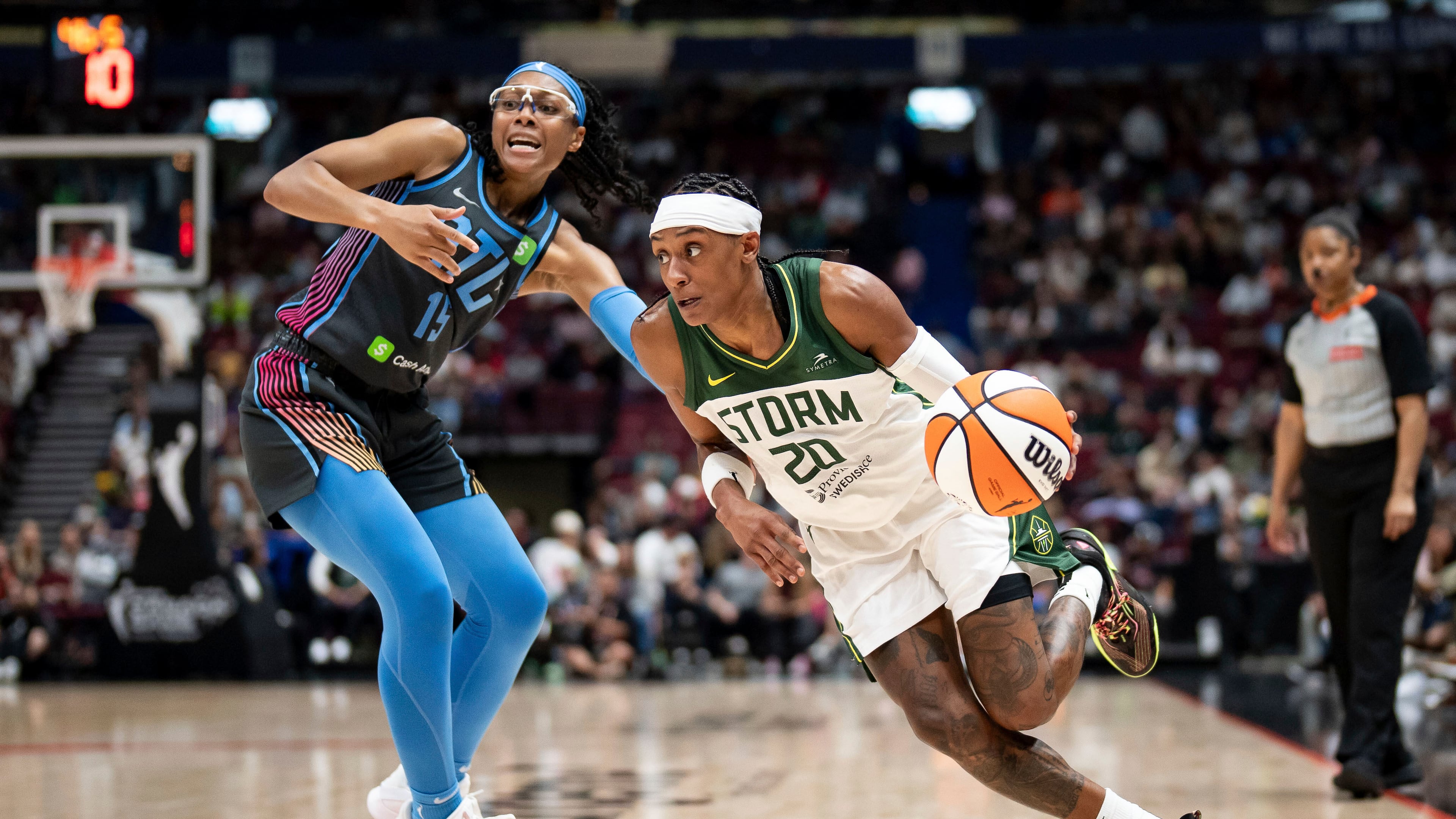 Seattle Storm's Brittney Sykes (20) drives past Atlanta Dream's Allisha Gray (15) during the first half of a WNBA basketball game in Vancouver, British Columbia, on Friday, Aug. 15, 2025. (Ethan Cairns/The Canadian Press via AP)