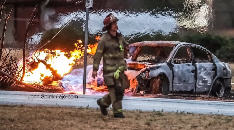 Leaking gas fed a fire on Grayson Highway after a car crashed into a power pole and ruptured a gas line.